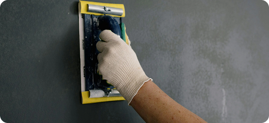 Plasterer finishing wall with attention to detail